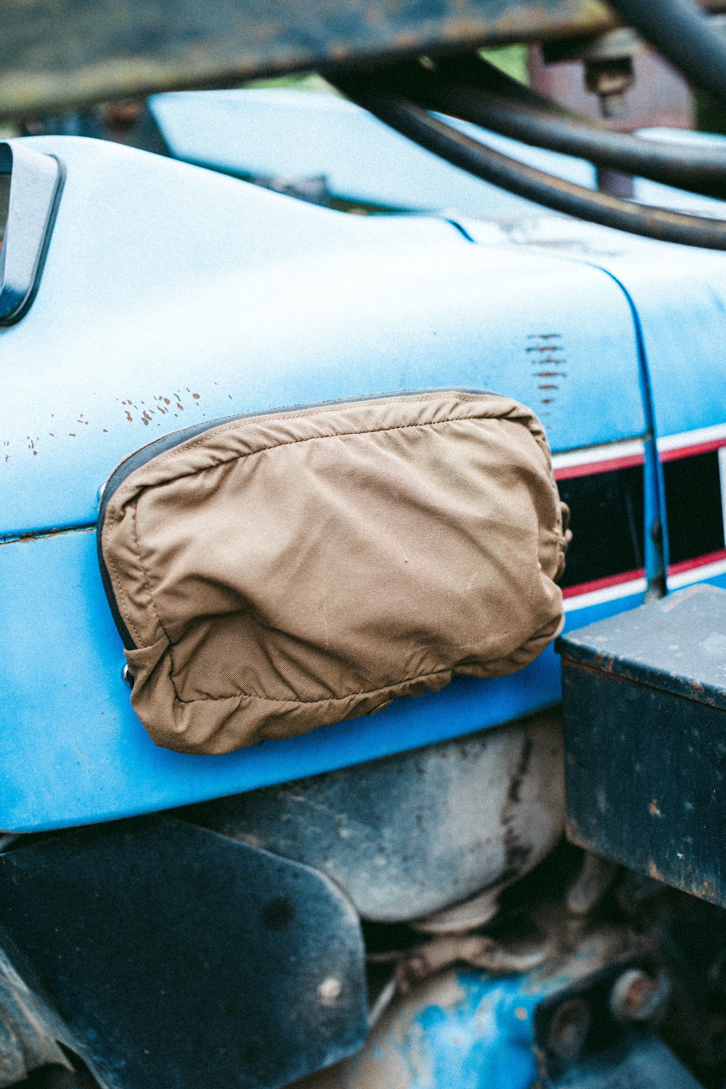 MOLLE panel mounted to the inside of a tractor cab holding a tan GP pouch for quick-access storage.