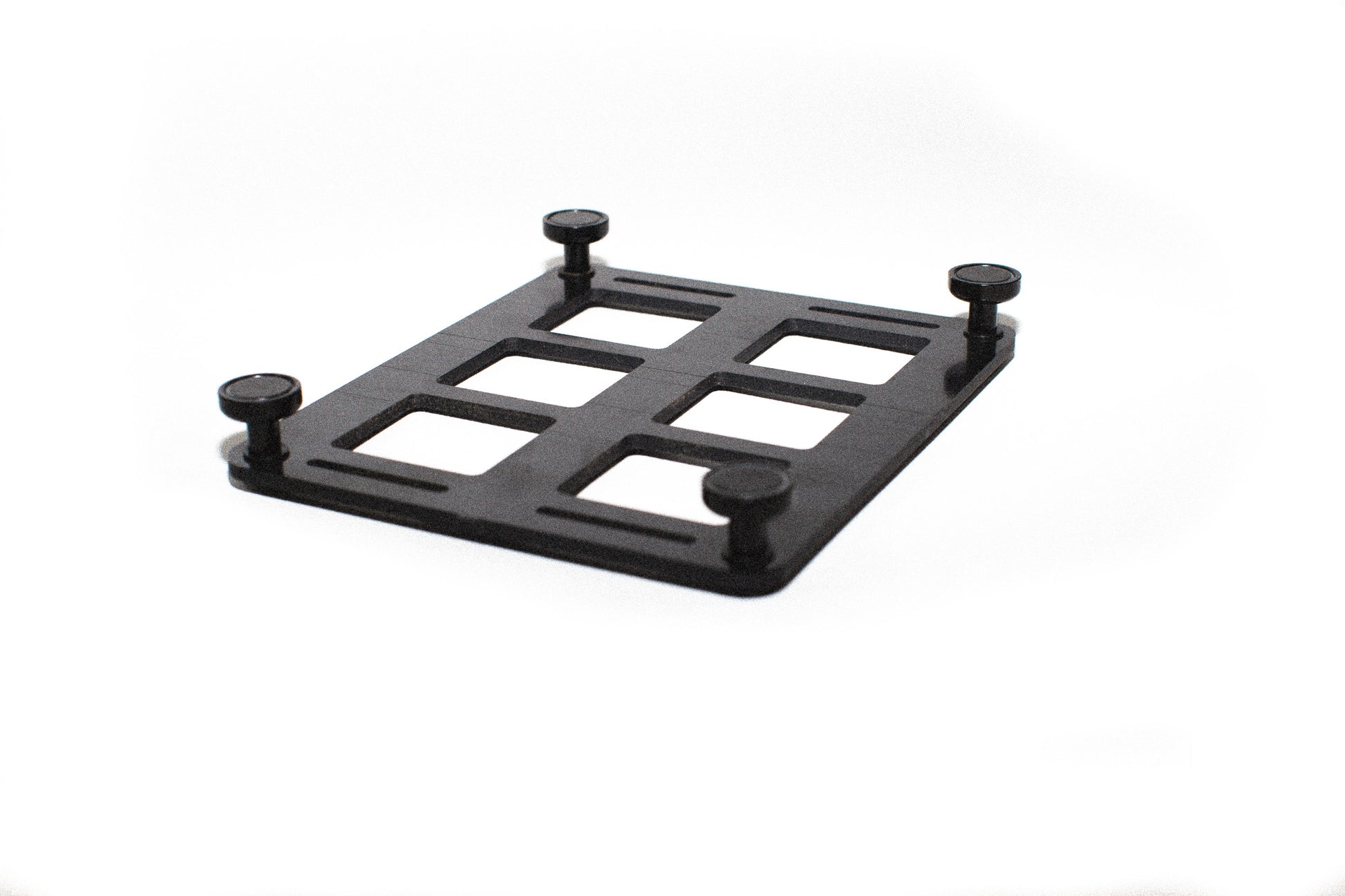 6-slot ABS MOLLE panel flipped upside down to show the magnetic mounting feet attached for securing to metal surfaces.
