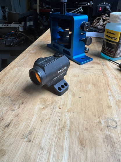 Aimpoint Micro red dot mounted on Homestead Defense 35mm piggyback scope ring cap adapter during test fit on the workbench