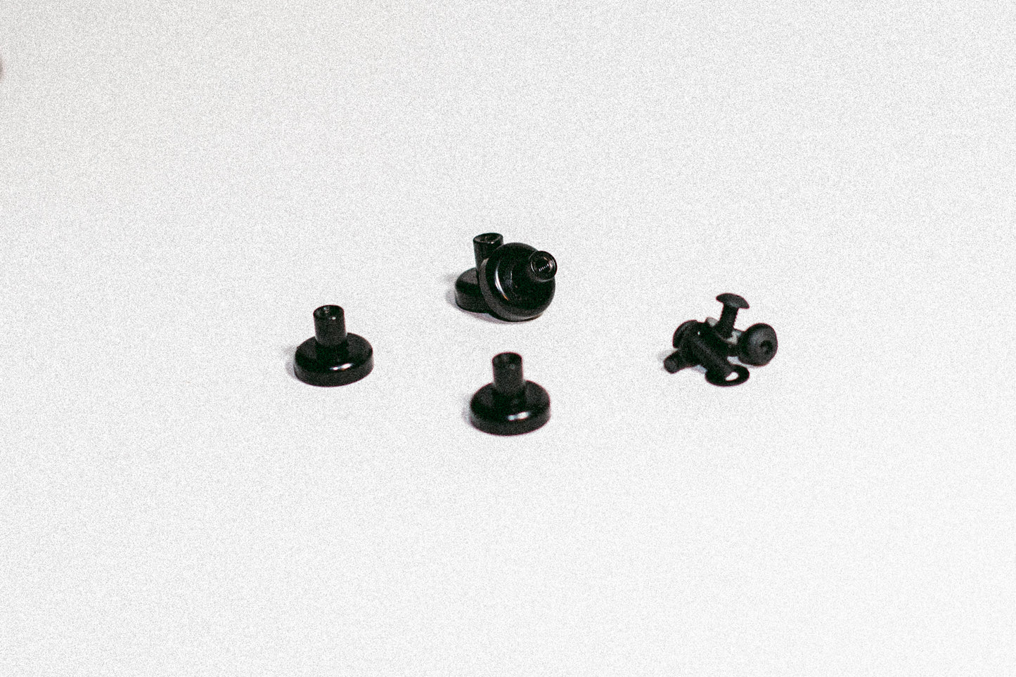 Magnet kit for MOLLE panels including four threaded neodymium pot magnets with black epoxy coating and button-head hardware.