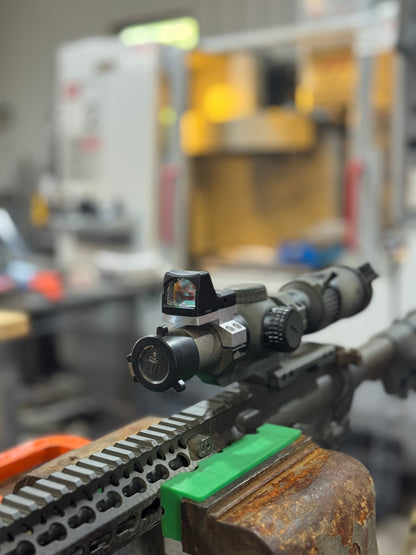 Close-up of Vortex 30mm piggyback cap adapter with Aimpoint Micro optic mounted on AR-15 rifle setup.