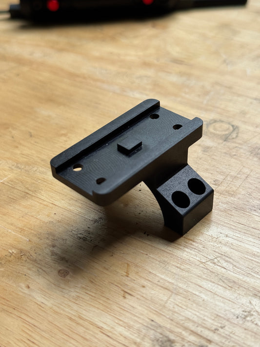 Vortex 30mm Aimpoint Micro piggyback scope ring adapter machined from anodized billet aluminum on a wooden workbench.