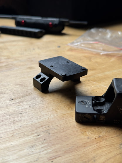 RMR optic piggyback mounted on top of a Vortex 30mm cantilever mount installed on an AR-15 rifle